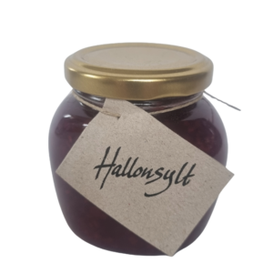 Burk med hallonsylt från Fristorps gård med mörkröd färg och synliga bär.